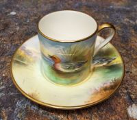 A Minton coffee can and saucer,  painted by S. Holland, signed, with continuous scene with  a duck
