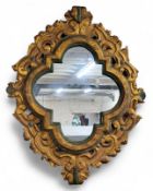 A large Italian Rococo carved giltwood mirror, recent looking glass, showing signs of age, 120cm