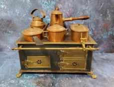 A late 19th century child's cooking range, with copper kettle, coffee pot, saucepan, two handled pot