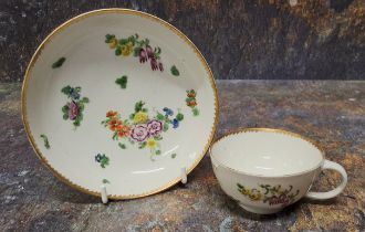 A Bristol teacup and saucer,  painted with colourful summer flowers, gilt dentil rim, c.1780