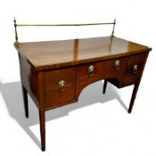 A George III mahogany sideboard, brass gallery above  long drawer flanked by deep drawer and