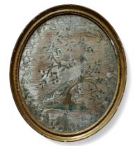 A fine Regency oval silkwork embroidery panel depicting an aesiatic pheasant on a tree of life