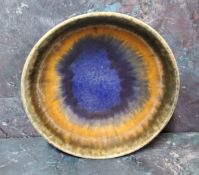 A Ruskin matt crystalline footed bowl, decorated in a dripped blue, orange and tan glazes, i20.5cm