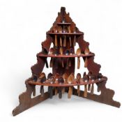 An unusual 19th century farmhouse pine three tier corner spoon rack, complete with thirty-two