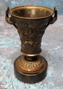 A 19th century bronze urn, of waisted cylindrical form, cast with scrolling foliage, scroll handles,
