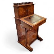 A Victorian burr walnut Davenport, the pierced fretwork gallery above two satinwood inlaid