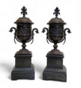 A pair of late 19th century black marble side vases, of urnular form, banded in relief after the