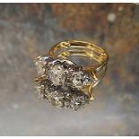 An impressive 18ct gold diamond ring, the central claw set oval diamond , flanked by two smaller