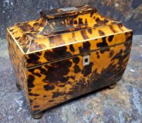 An early Victorian tortoiseshell bowed rectangular tea caddy, hinged pagoda top, two lidded