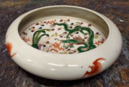 A Chinese circular bowl, decorated with dragon and phoenix, the exterior with bats, in polychrome,