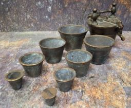 A set of eight Nuremberg type bronze nesting cup weights, from 2/10 to 10oz Troy, the largest 7cm