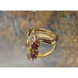 An 18ct gold diamond and ruby ring, the claw set diamond approx 0.25ct and the round ruby set on a