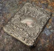 An Edwardian silver rounded rectangular visiting card case, embossed with  leafy scrolls and