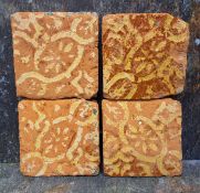 Four Medieval encaustic pottery square tiles, decorated with stylised flowers and scrolls, 10.5cm
