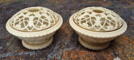 A pair of Graingers Worcester reticulated pot pourri vases, in relief with stiff acanthus leaves,