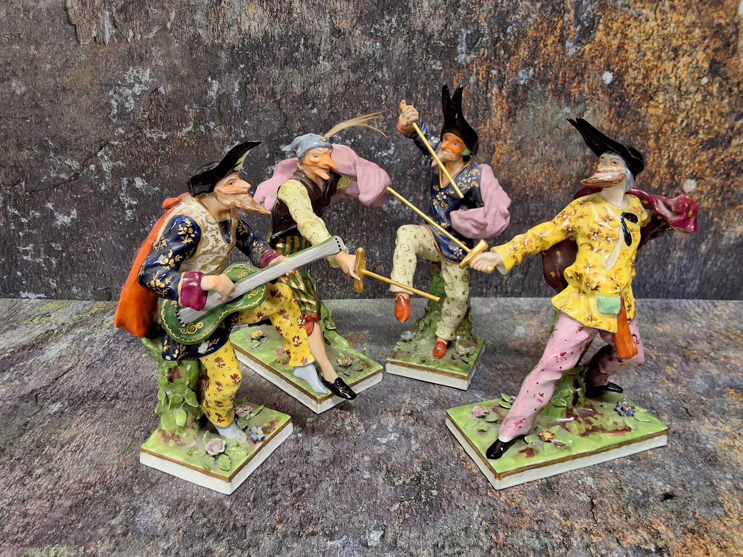 A set of four Continental 'Derby' Samson Commedia dell'arte figures, brightly decorated three with