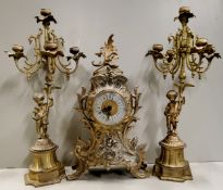 A Louis XV style Frech gilded metal mantel clock with candelabras, clock 40cm high, 20th century.