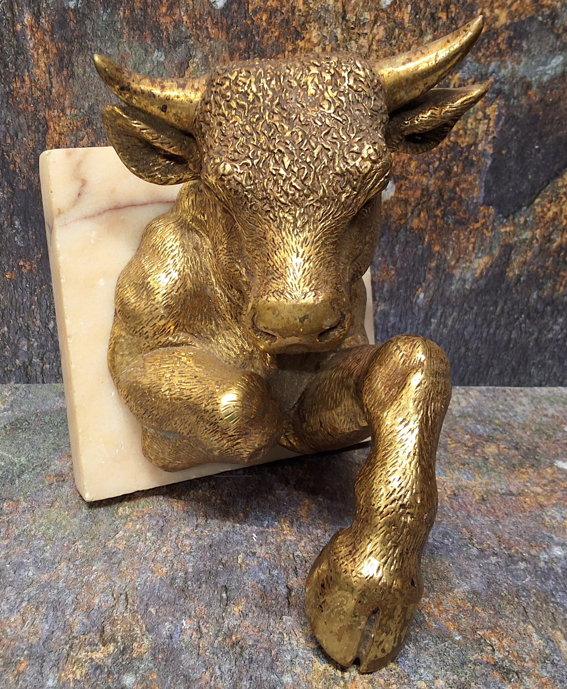 A gilt bronze Tarus the Bull wall plaque, square marble plaque, 18cm high