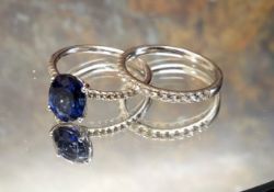 An 18ct gold sapphire and diamond solitaire, the four claw set oval sapphire, approx 9.1 x 7.1 x 4.5