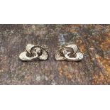 A pair of 18ct white gold and diamond contemporary earrings, two interlinked ellipses, centrally