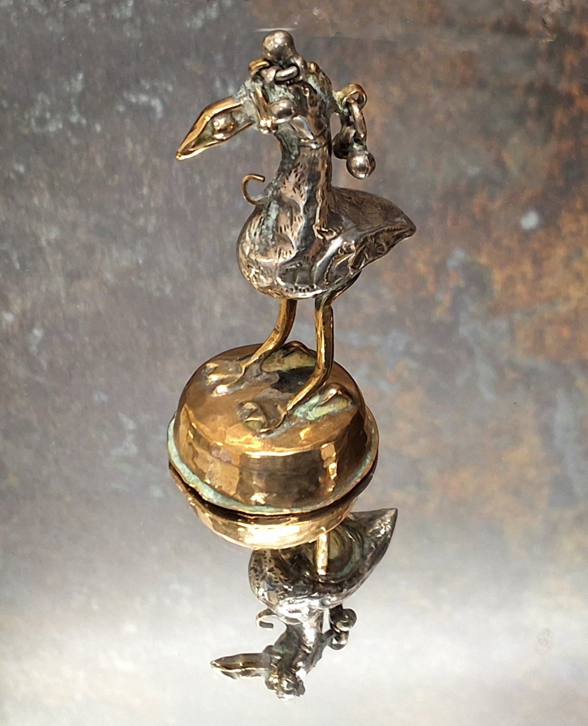 A Burmese plated opium weight, in the form of a bird, 6.25cm high, 19th century