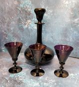 A Victorian amethyst glass decanter and stopper, 30cm high, c.1860; a set of three funnel shaped