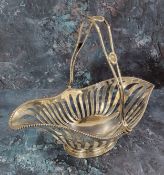 An Edwardian silver swing-handled bread basket, the handle with three beaded bosses, beaded rim