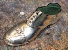 A George V silver novelty pin cushion, as a shoe, 12.5cm wide, Chester 1912