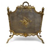 A Louis XVI-style gilt brass fire screen, of shaped rectangular form, ribbon tied laurel leaf