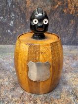 An early 20th century novelty tobacco biscuit barrel, the cover with comical black man finial,