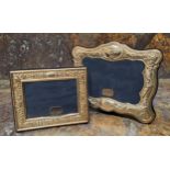 A Victorian style silver shaped rectangular easel photograph frame, embossed with flowers, 14cm x