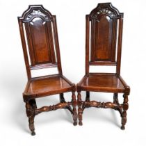 A pair of 17th century Charles II oak hall chairs c.1680, 120cm high, 46cm wide, 53cm deep, seat