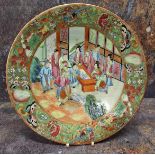 A 19th century Cantonese circular plate, decorated in the typical palette, with figures in an