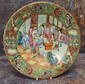 A 19th century Cantonese circular plate, decorated in the typical palette, with figures in an