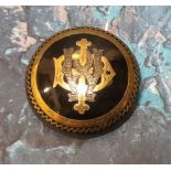 A Victorian circular tortoiseshell mongramme brooch pique inlaid with yellow and white metal