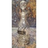 A Victorian wrythen clear glass liqueur bottle and stopper, silver sleeve, pierced with C-scrolls,