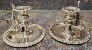 A pair of George IV silver chambersticks, campana sconces,