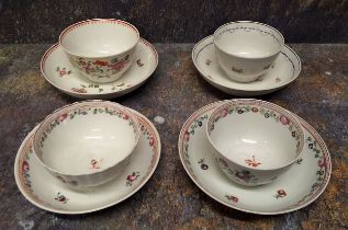 A Newhall  tea bowl and saucer, decorated with scattered flowers, blue husk and dot undulating