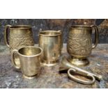 A pair of Indian silver spreading cylindrical mug, pedestal base, embossed in relief with foliage