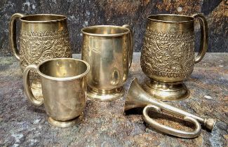 A pair of Indian silver spreading cylindrical mug, pedestal base, embossed in relief with foliage