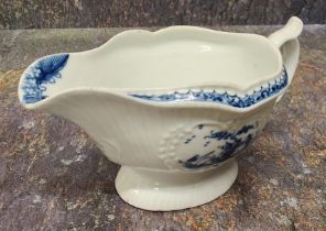 A Worcester Little Fisherman pattern sauce boat, loop handle, scroll thumb piece, painted in