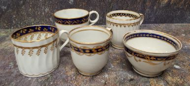 A Newhall tea bowl and coffee cup, banded in cobalt picked out in gilt, c.1800; a spirally fluted