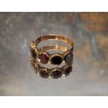 An early 19th century yellow metal and amethyst ring, set with five round amethyst stones, size O