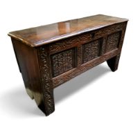 A mid 17th century English oak and elm heavily carved coffer c.1650, 66cm high, 117cm wide, 41cm