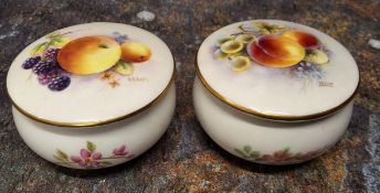 A pair of Royal Worcester circular boxes and covers, painted by  PM Platts and  G. Banks, signed