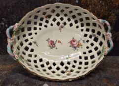 A Chelsea Derby oval two handled pierced   basket,  painted with scattered roses and other flowers,