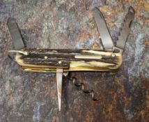 A Stan Shaw pocket knife, two blades, saw, awl and corkscrew, stag scales, vacant cartouche, brass