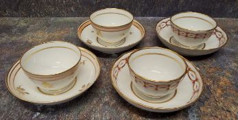A pair of Newhall fluted tea bowls and saucers, decorated with gilt ovals and fink foliage, c.