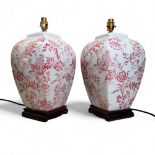 A pair of 20th century panelled side lamps, printed in red with blossoming branches, 38cm high