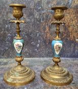 A pair of 19th century gilt metal mounted and porcelain table candlesticks, in the Sevres manner,